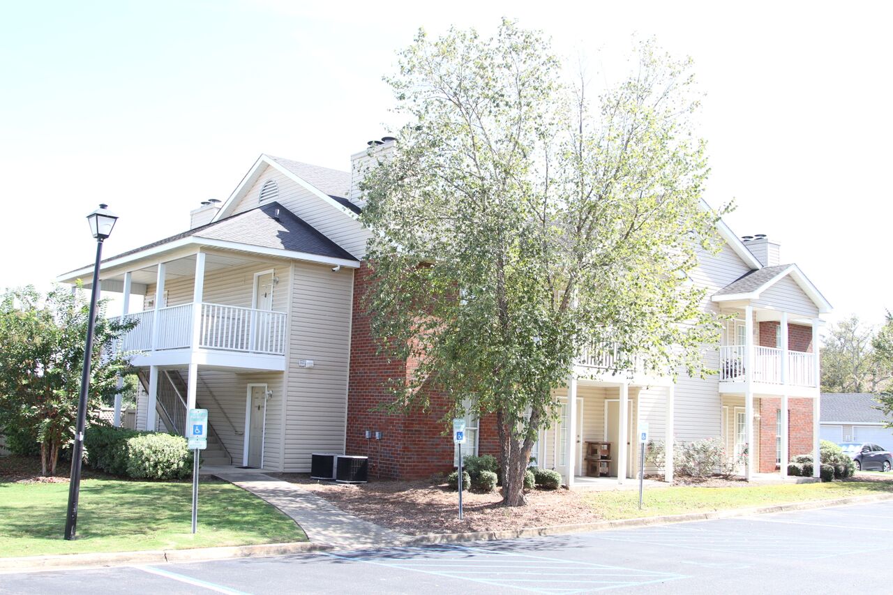 the exterior of a building with a tree in front of it